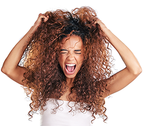 Woman pulling at her curly hair in frustration